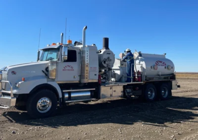 Front angle view of an oilfield hot oiler truck on site