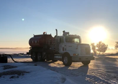 Oilfield service truck positioned near well site equipment