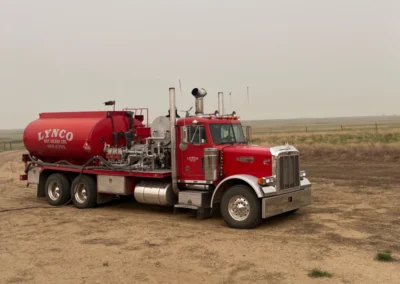 Hot oiler truck in action with steam visible during oilfield treatment